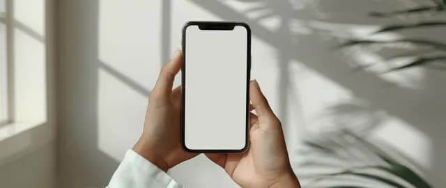 Person holding smartphone with blank screen, typing gesture in bright home interior